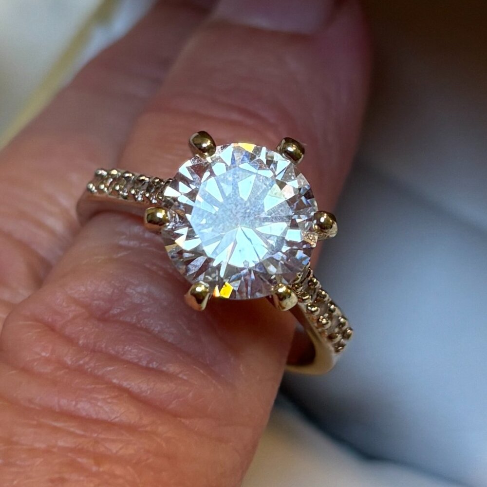 Beautiful, large cubic zirconia solitaire ring with side diamonds. Size 8